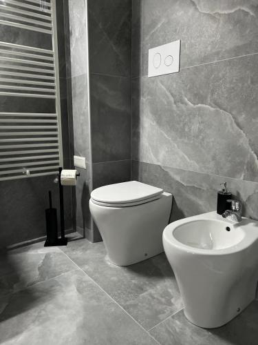 a bathroom with a toilet and a sink at Harmony Affittacamere in Tortolì