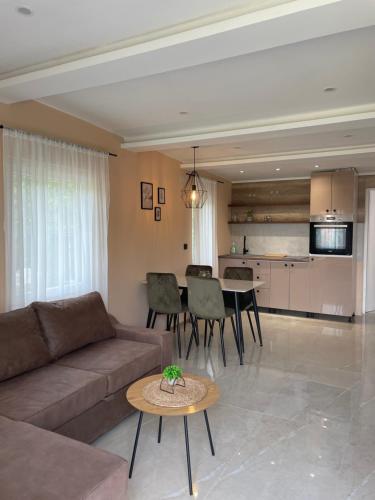 a living room with a couch and a table at Bungalovi Izvor Plive in Šipovo