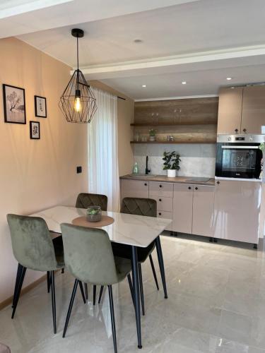 a kitchen and dining room with a table and chairs at Bungalovi Izvor Plive in Šipovo