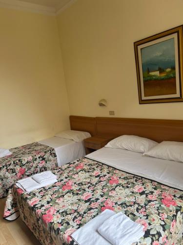 Ένα ή περισσότερα κρεβάτια σε δωμάτιο στο Hotel Liberty