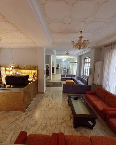 a large living room with couches and a pool table at Hotel Liberty in Montecatini Terme