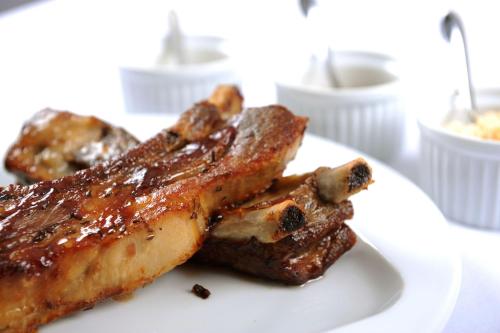a white plate with two pieces of meat on it at Hotel Berg in Staré Splavy