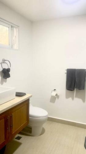 a bathroom with a toilet and a sink and towels at B3 beautiful ocean view penthouse - Ocean Front in Cabarete