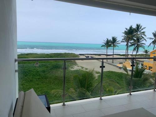 a balcony with a view of the beach at B3 beautiful ocean view penthouse - Ocean Front in Cabarete
