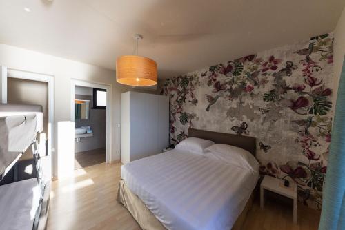 Un ou plusieurs lits dans un hébergement de l'établissement Hotel Miranda