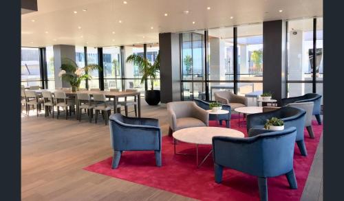 a restaurant with tables and chairs and windows at Southbank, River View, Free Parking in Melbourne