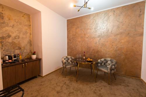 a dining room with a table and two chairs at Al Centro in Bucharest