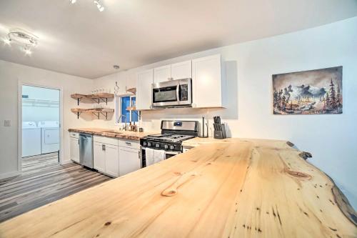 a large kitchen with a wooden table in it at Apartment in Anchorage -10 Mi to Alaska Zoo! apts in Anchorage