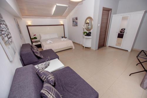 a living room with a couch and a bed at Ammolithos Beach in Stavros