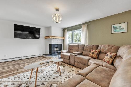 a living room with a couch and a fireplace at Apartment in Anchorage -10 Mi to Alaska Zoo! apts in Anchorage