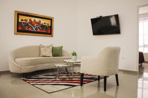 a living room with a couch and a table at El Principe Hoteles in Piura
