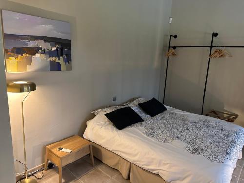a bedroom with a bed and a lamp in it at Gite Monet in Bouchet