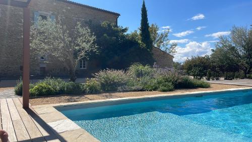a swimming pool in a yard next to a house at Gite Monet in Bouchet
