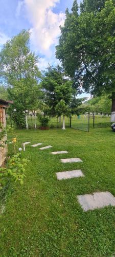 a park with stepping stones in the grass at Petit Castel in Bran
