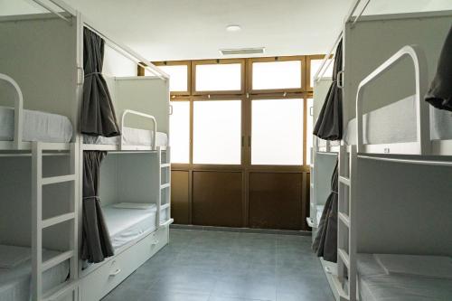 a room with bunk beds and a large window at Sea Hostel Barcelona in Barcelona