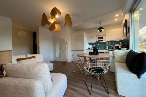a living room with a couch and a table at Family apartment near the sea of Houlgate in Houlgate