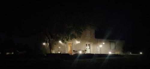 a house with a tree in front of it at night at Ets CAPMASIL - chambre 1920 in Virac