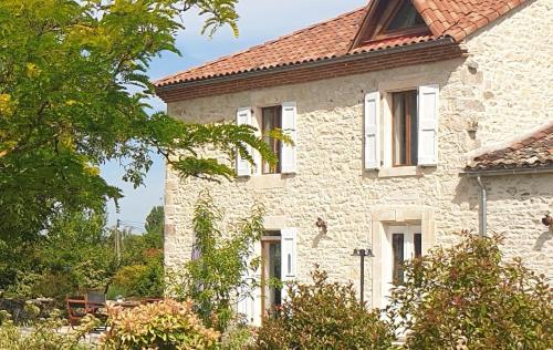 a large stone house with a red roof at Ets CAPMASIL - chambre 1920 in Virac