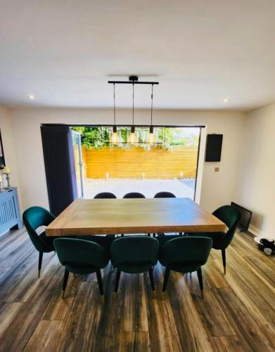 a dining room with a wooden table and chairs at 3 Bedroom Guest House in Dudley in Dudley