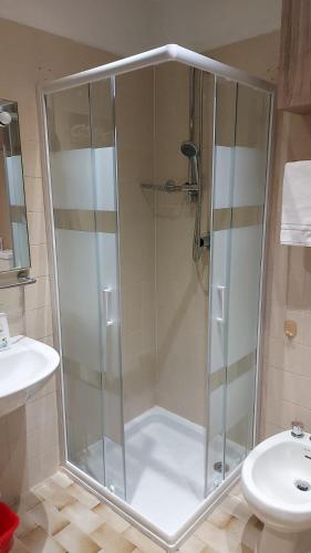 a shower with a glass door in a bathroom at Casa Focobon - presso Sussy residence in Falcade
