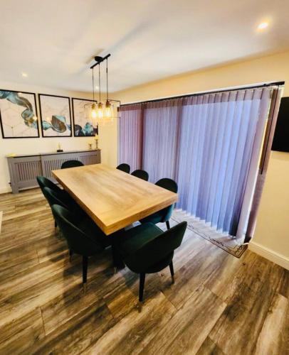 a conference room with a wooden table and chairs at 3 Bedroom Guest House in Dudley in Dudley