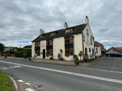 a large white building on the side of a street at The Blue Bell in Boroughbridge