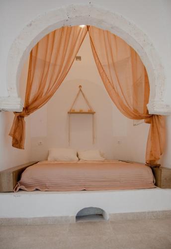 a bed in a room with a large window at Villa Bahia Djerba in Houmt Souk