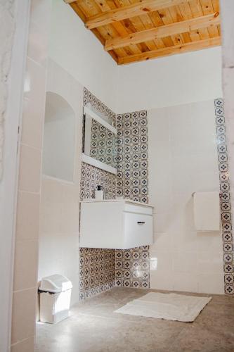 a bathroom with a sink and a tile wall at Villa Bahia Djerba in Houmt Souk
