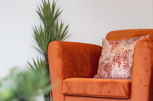 an orange chair with a brown pillow on it at 3BR House in Prime Barnet Location with Driveway in Barnet