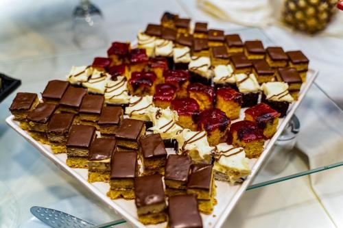 a tray of chocolate and other desserts on a table at MPM Hotel Guinness in Bansko