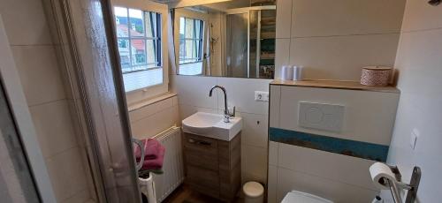 a small bathroom with a sink and a mirror at Haus der Geschenke - Carinthia in Velden am Wörthersee