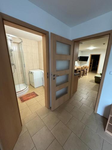 a room with a door and a bathroom with a toilet at Ubytování ProDante in Ostrava