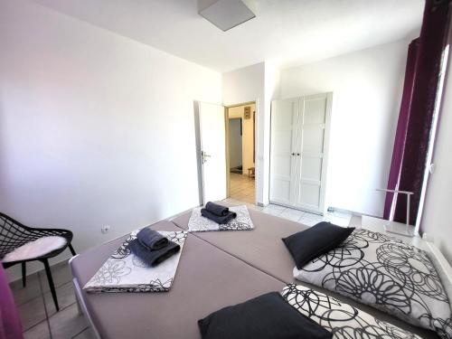 a room with a table and a bed and a chair at Apartments Pitve in Jelsa