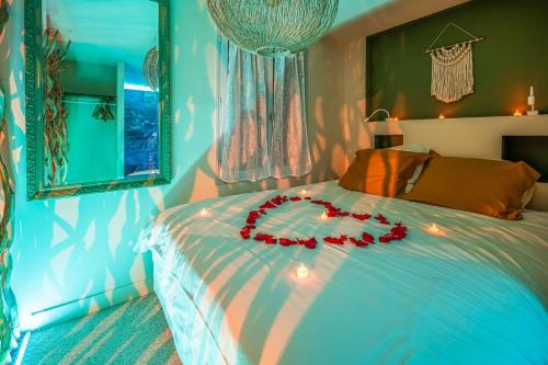 a bedroom with a bed with a red bow on it at OIQIA • Bali in Narbonne