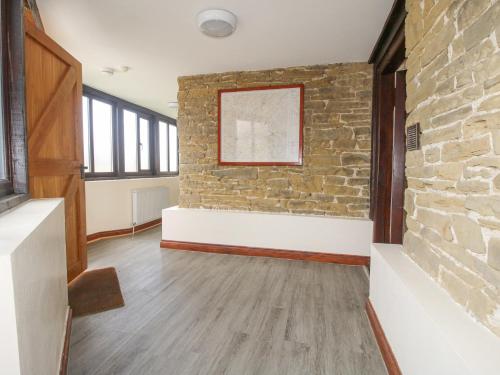 a room with a stone wall and a brick wall at The Walton in Craven Arms