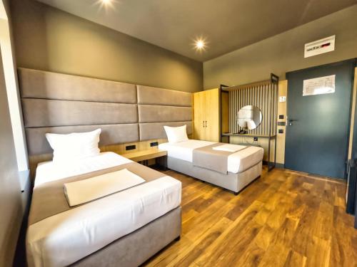 Ένα ή περισσότερα κρεβάτια σε δωμάτιο στο VIGOR Hotel