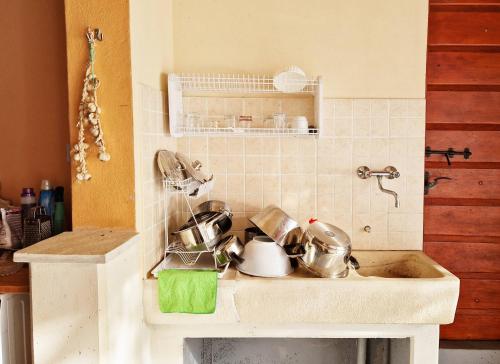 a kitchen sink with pots and pans on it at Apartman Dubravko Tribanj in Starigrad