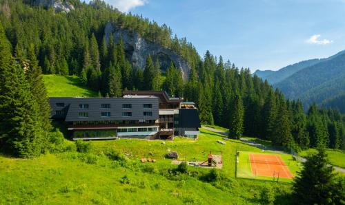 a building on a hill in the mountains at Wellness Hotel Repiska in Demanovska Dolina