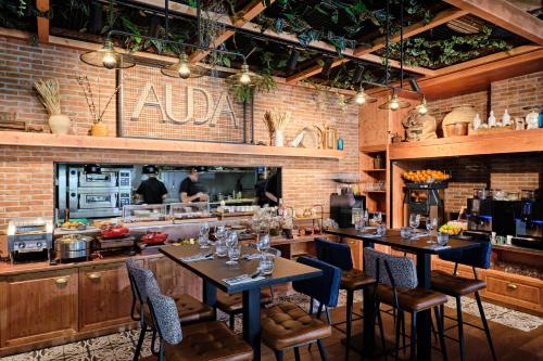 a restaurant with tables and chairs and a kitchen at Appart Hotel Odalys City Marseille Centre Euromed in Marseille