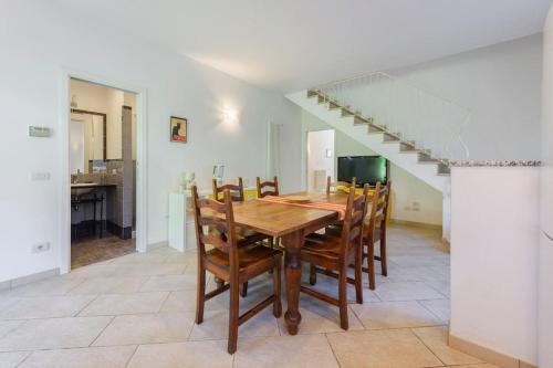 a dining room with a wooden table and chairs at Golden Luxe - Villa in the center next the sea whit garden FDM in Forte dei Marmi
