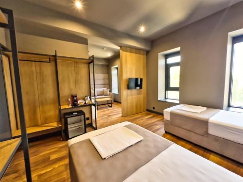 Ένα ή περισσότερα κρεβάτια σε δωμάτιο στο VIGOR Hotel