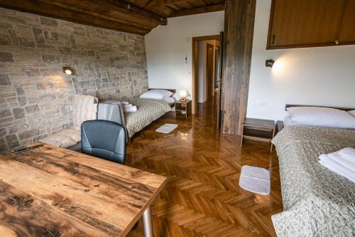 a living room with two beds and a table at Holiday House Zrinski with Pool, Sauna & Jacuzzi in Lepoglava