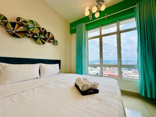 a bedroom with a white bed with a window at The Majestic Ipoh Town - Mountain View in Ipoh