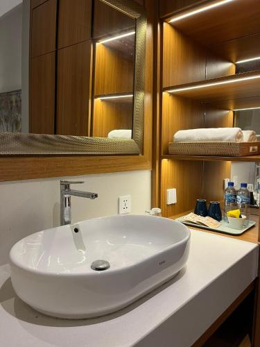 a bathroom with a white sink and a mirror at Brand New! Private Room near Canggu Surfing Beaches in Canggu