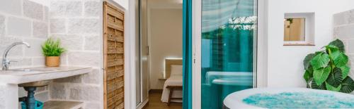 two views of a bathroom with a tub and a sink at La Calita Escondida - Jacuzzi y Cocina en Terraza Privada - Piscina y Parking Gratis in Chiclana de la Frontera