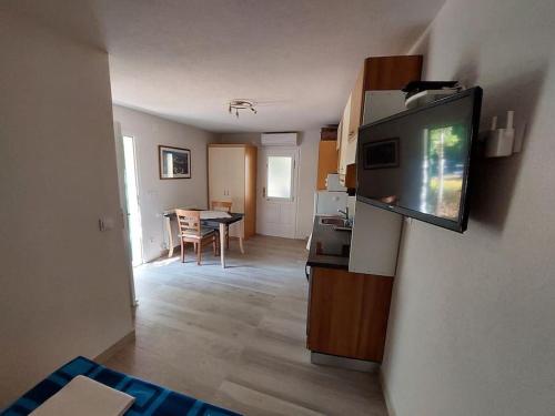 a living room with a flat screen tv on a wall at Apartman-Cottage Grgec in Jelsa