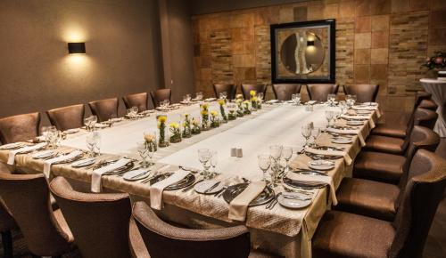 a long table in a room with chairs at Coastlands Musgrave Hotel in Durban