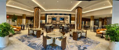 a hotel lobby with tables and chairs and a bar at Westchester Marriott in Tarrytown