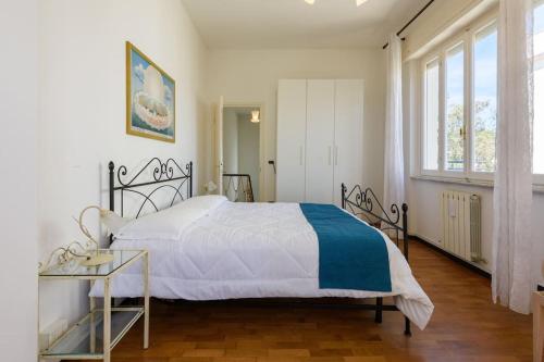 a bedroom with a bed and a large window at Golden Luxe - Roman Luxury Villa in the Sea in Camaiore