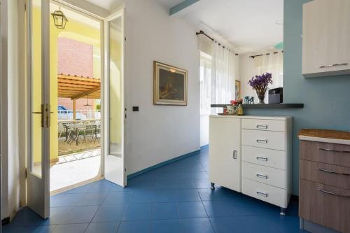a kitchen with a door leading to a patio at Golden Luxe - Roman Luxury Villa in the Sea in Camaiore